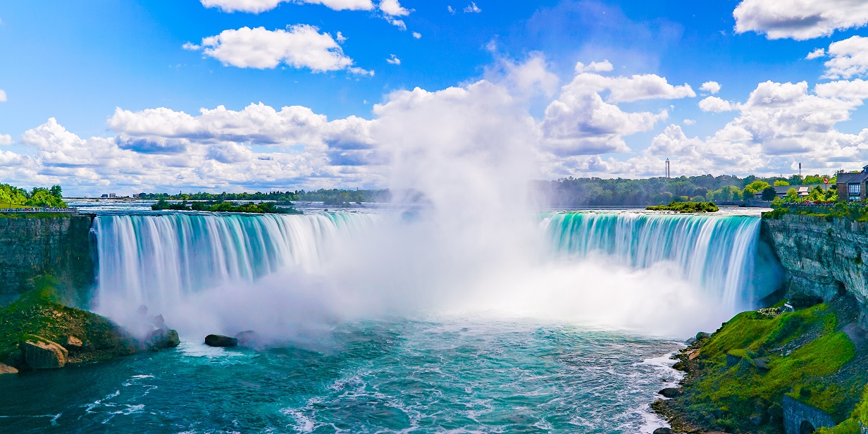 A beautiful scenic photo of the Niagara Falls on a nice sunny day.